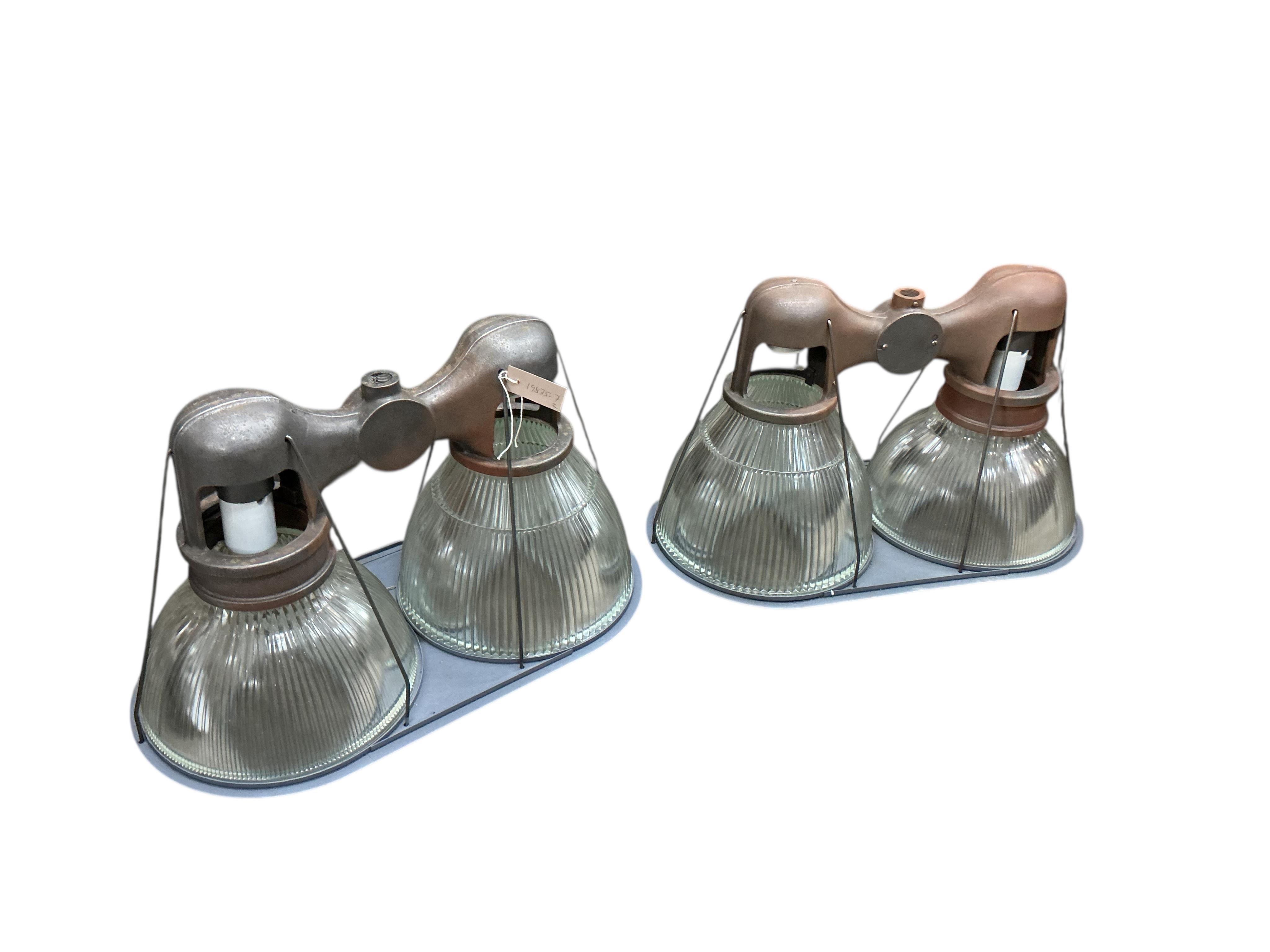 A pair of Holophane double industrial factory lights, width 64cm, height 42cm